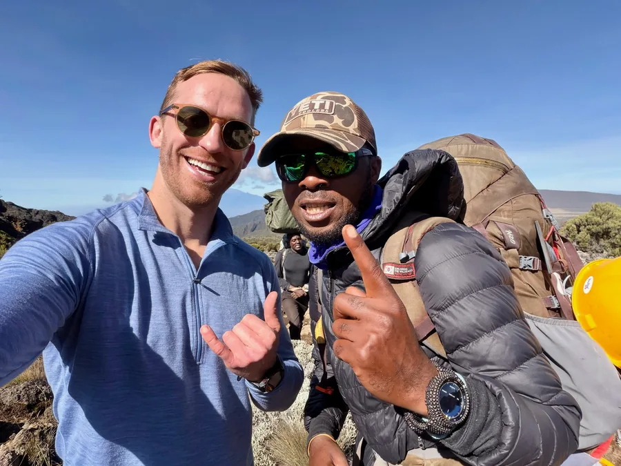 Climber with a local mountain guide on Kilimanjaro