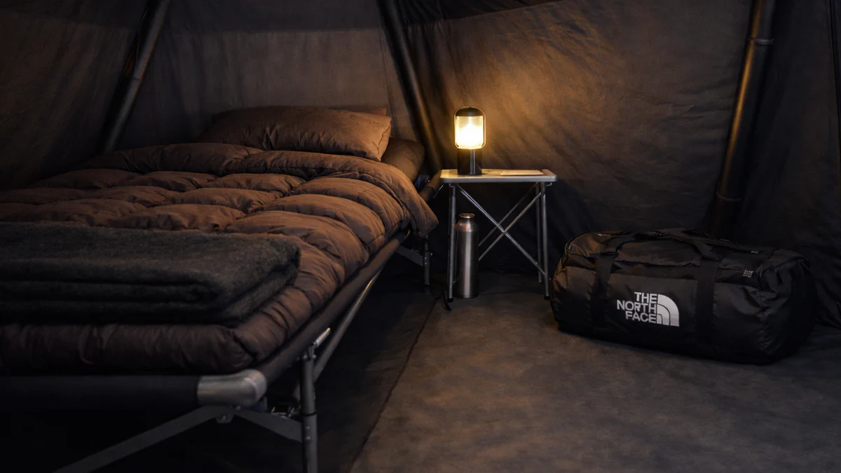 Elevated bed with Swiss down duvet inside an expedition tent